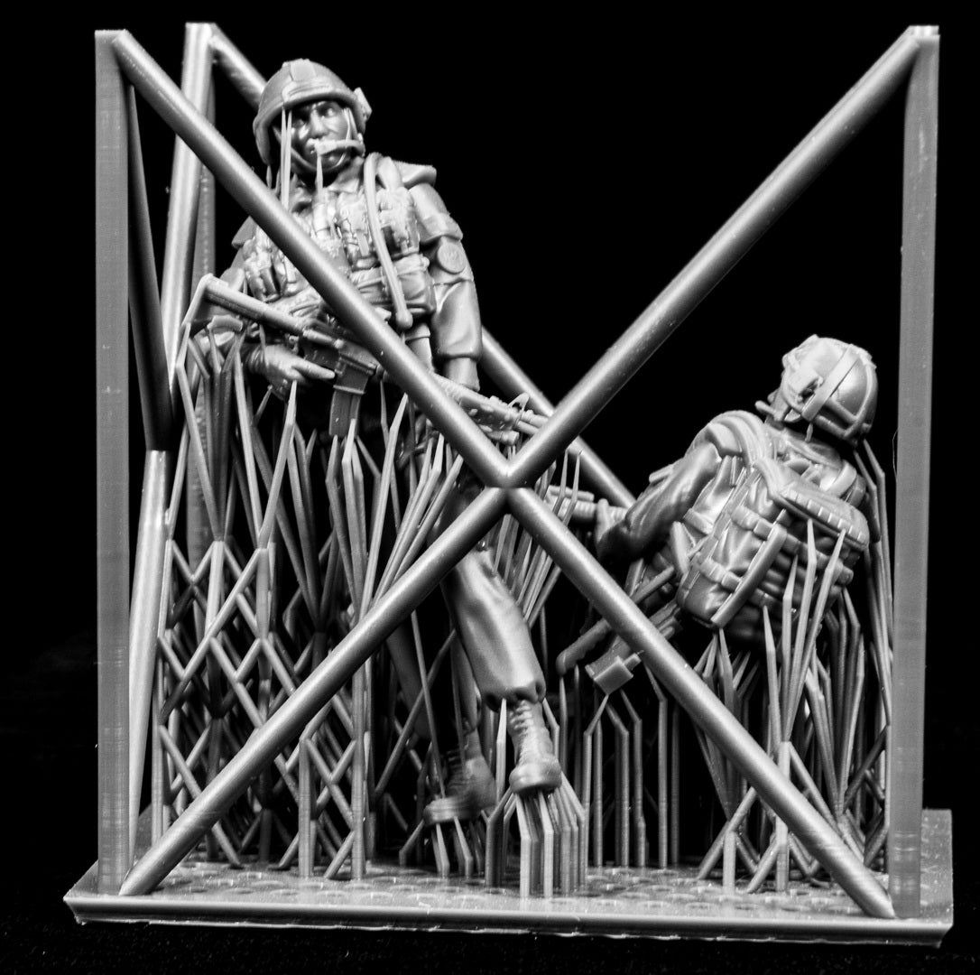 Two figures in armor standing behind black background
