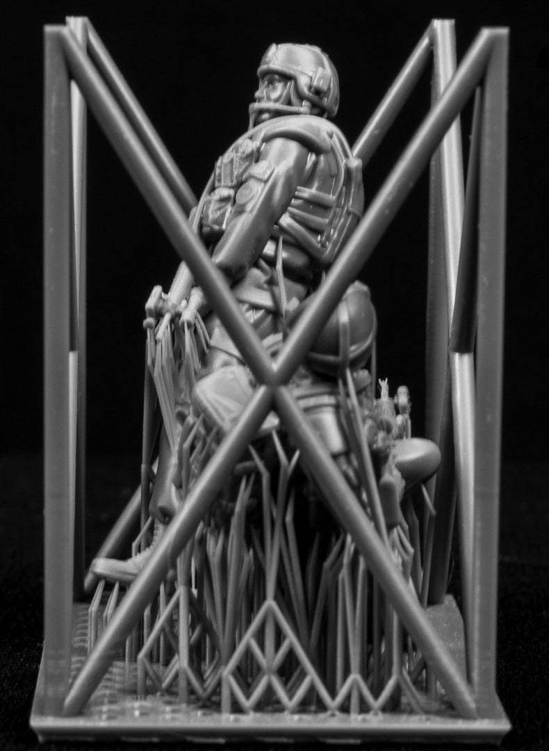 Model figure of a soldier on a stand with a dark background