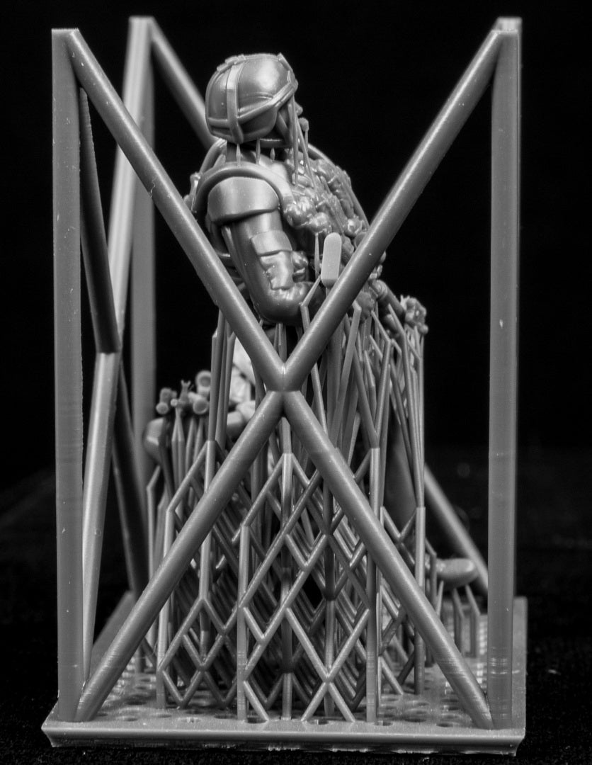Miniature figure with intricate detailing on a black background
