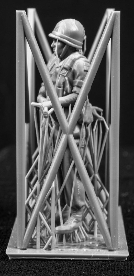 Two 3D Printed figures on a frame set on a black background.