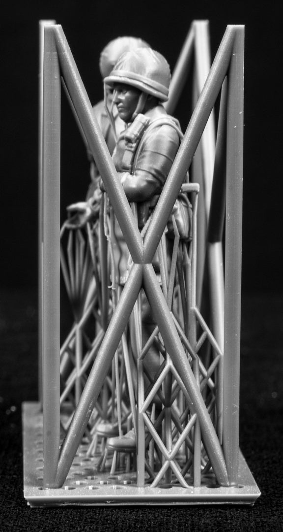 Two 3D Printed figures on a frame set on a black background.