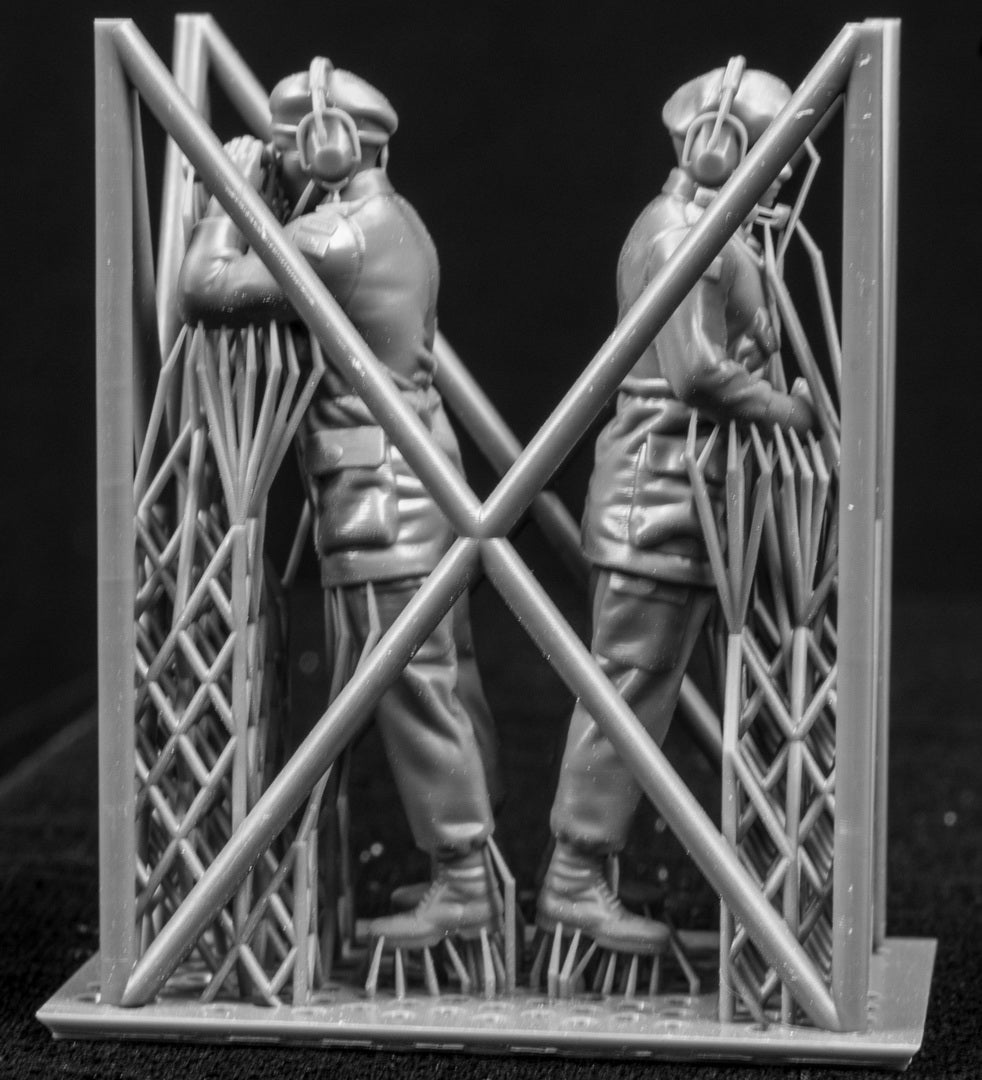 Two 3D Printed figures on a frame set on a black background.