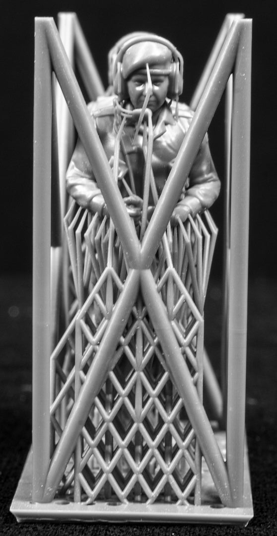 Two 3D Printed figures on a frame set on a black background.
