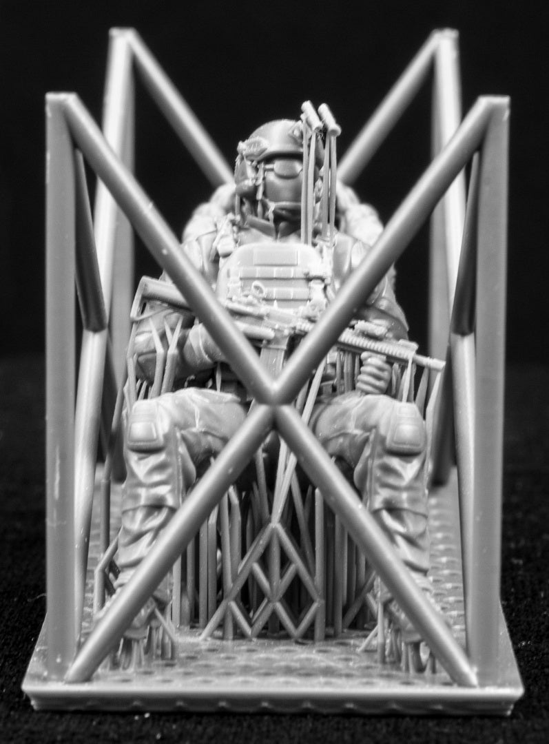 Two 3D Printed figures on a frame set on a black background.