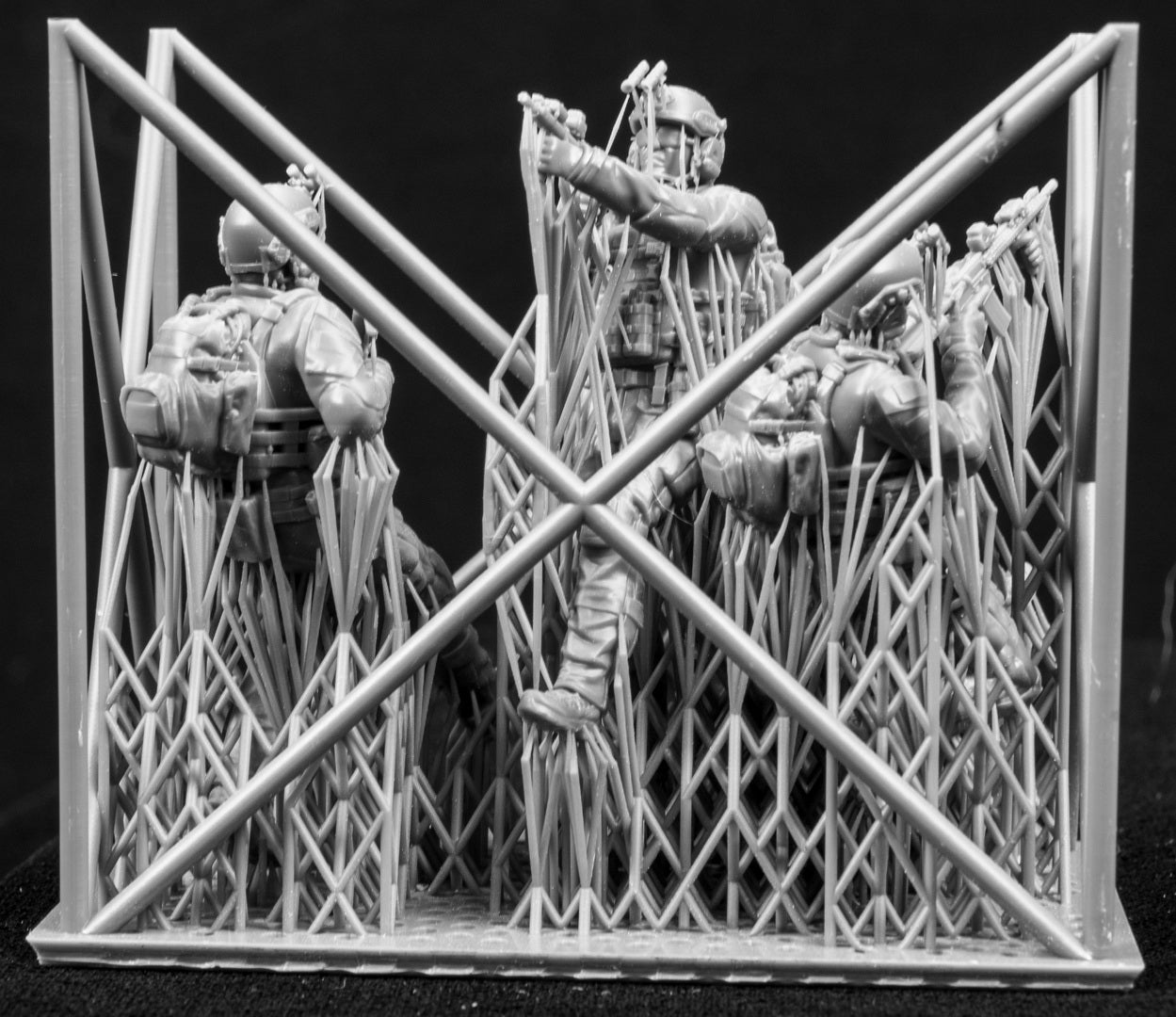 Three figures in a cage on a black background