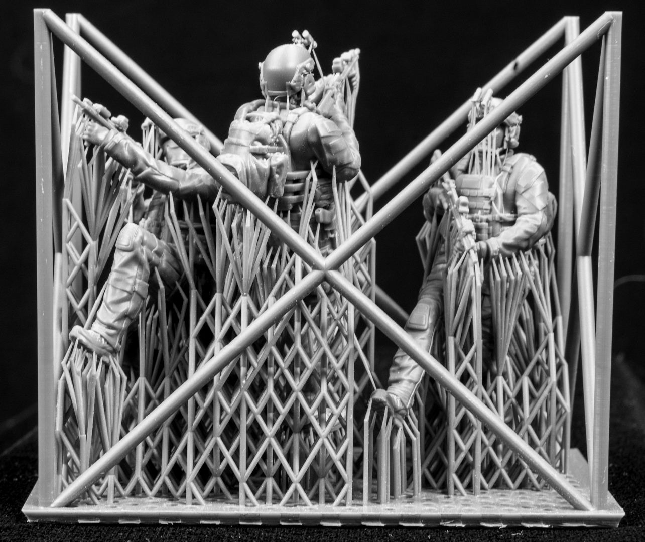 Three figures in a cage on a black background