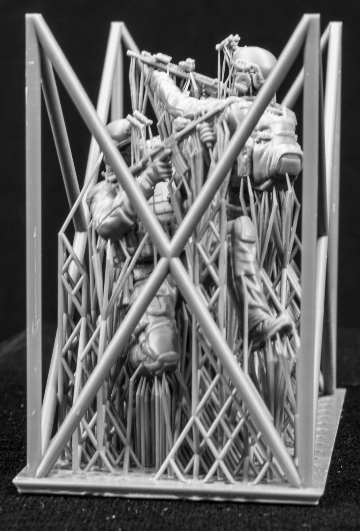 Three figures in a cage on a black background
