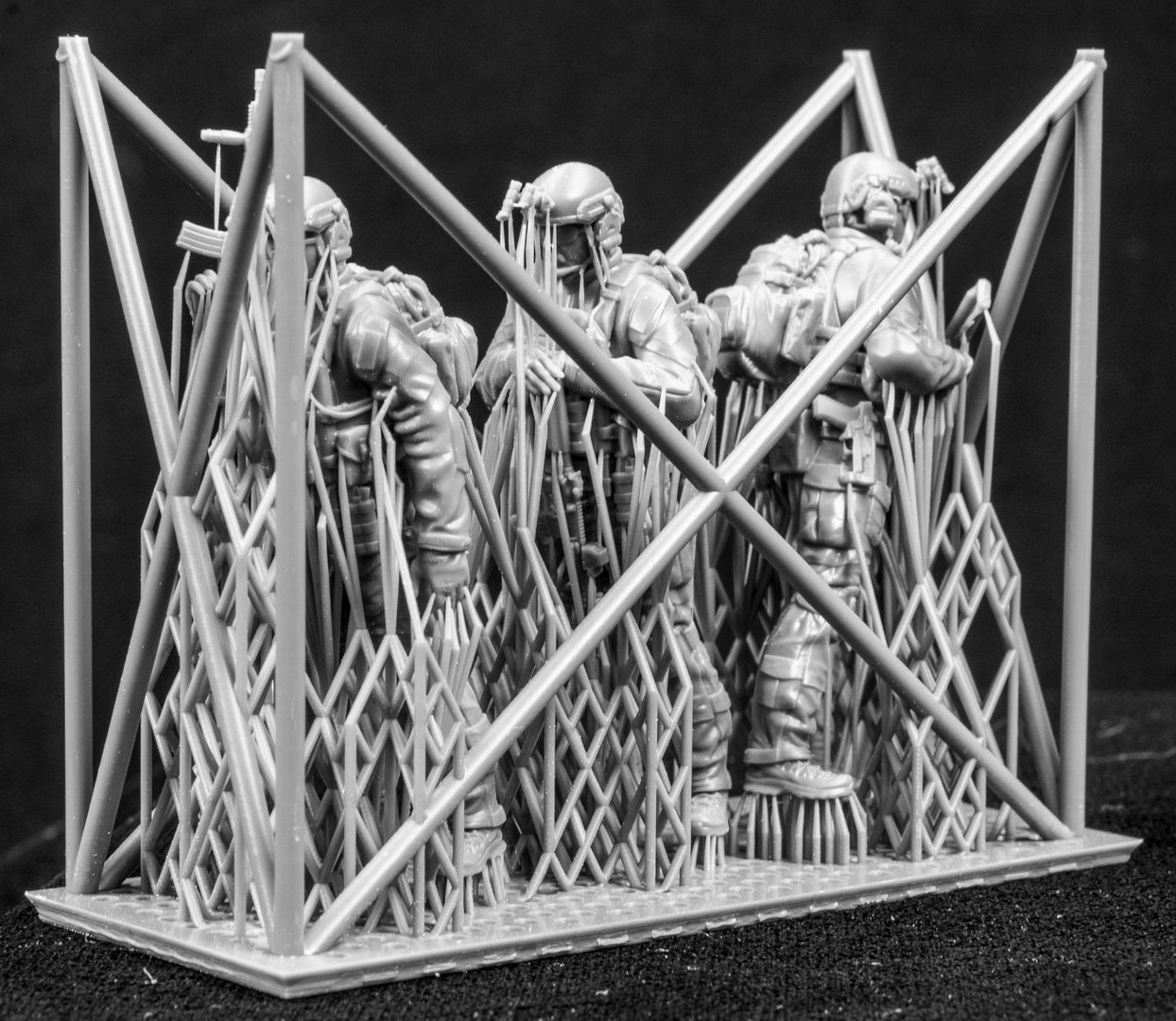 Three figures in a cage on a black background