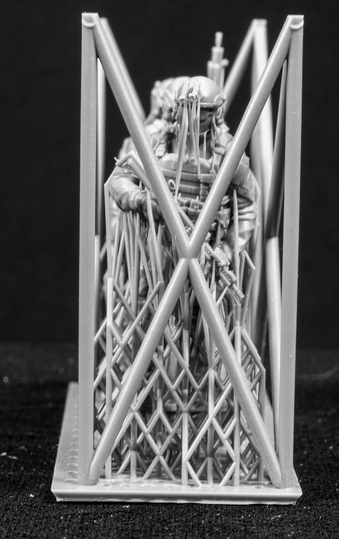 Three figures in a cage on a black background