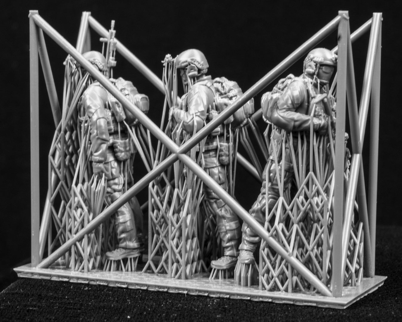Three figures in a cage on a black background