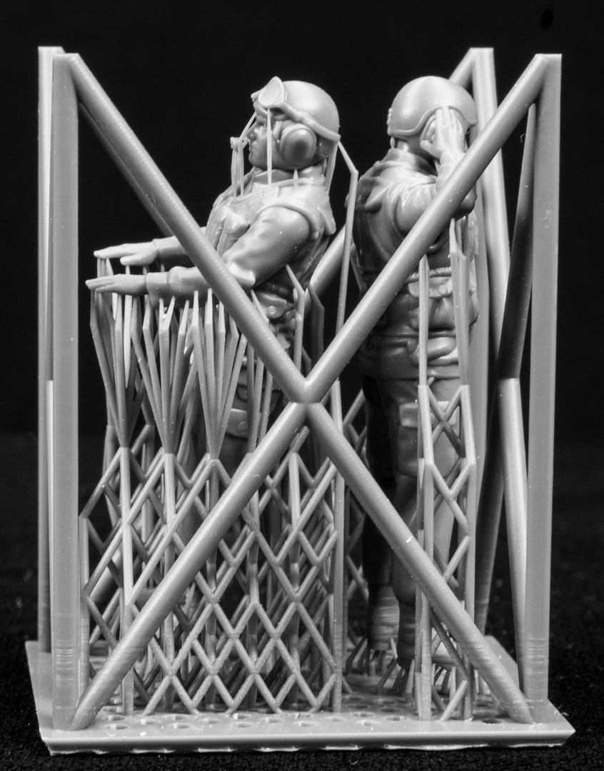 Two 3D Printed figures on a frame set on a black background.