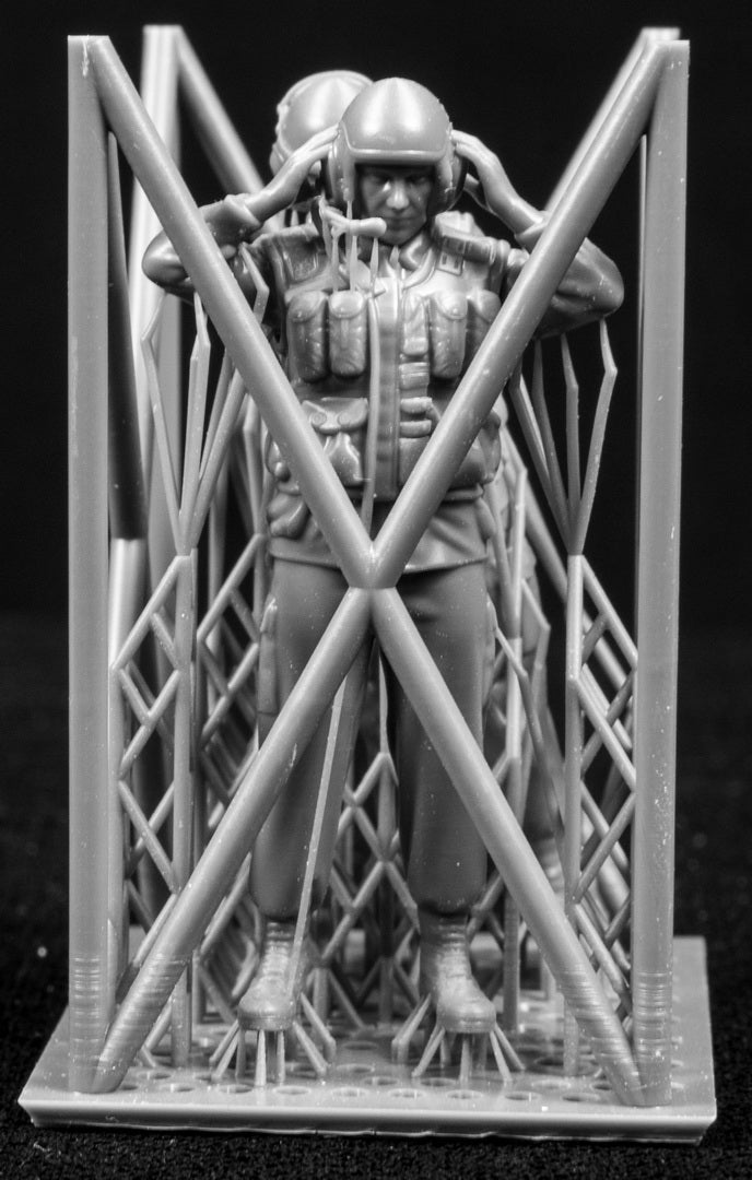 Two 3D Printed figures on a frame set on a black background.