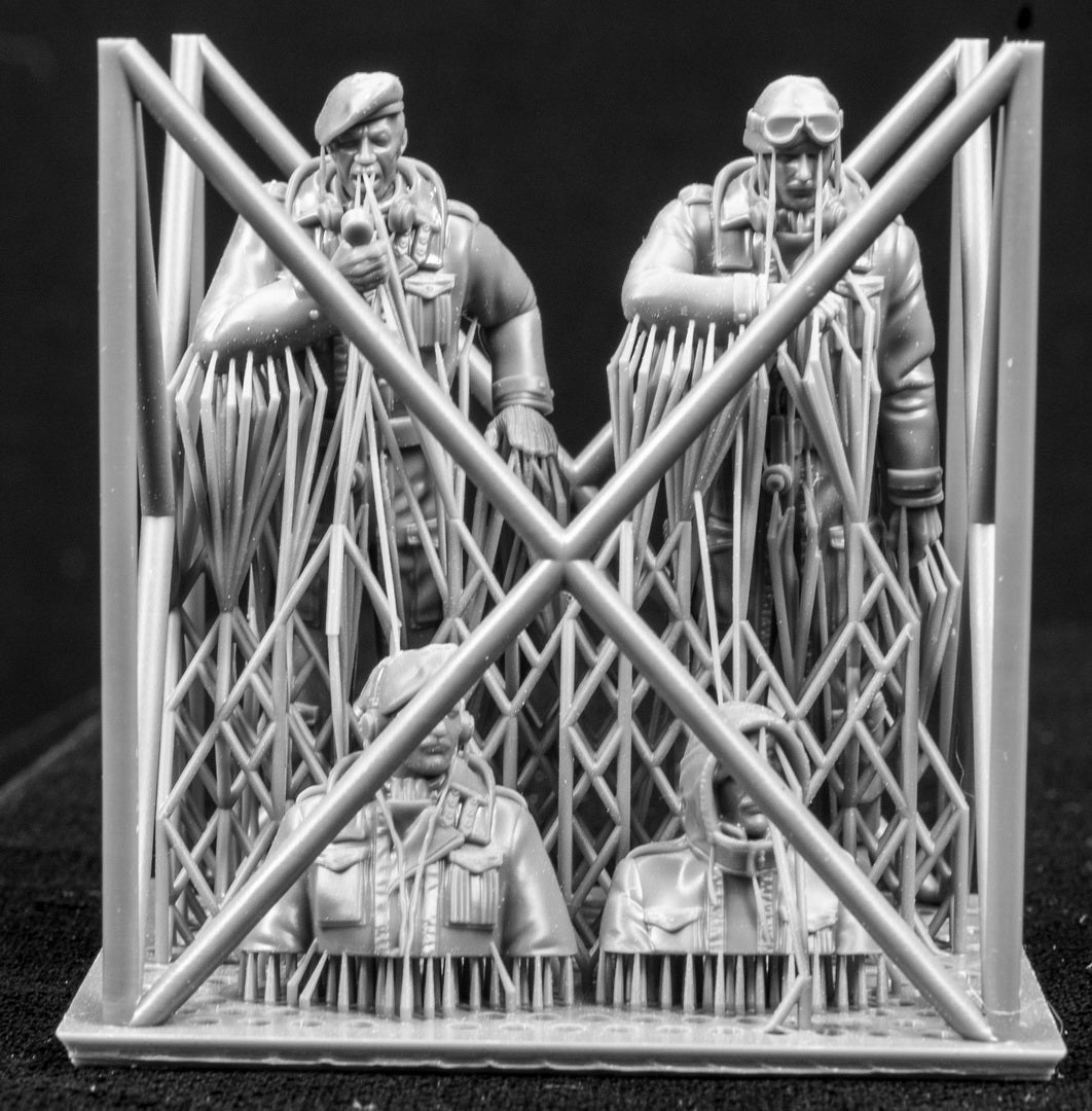 Four 3D Printed figures on a frame set on a black background.
