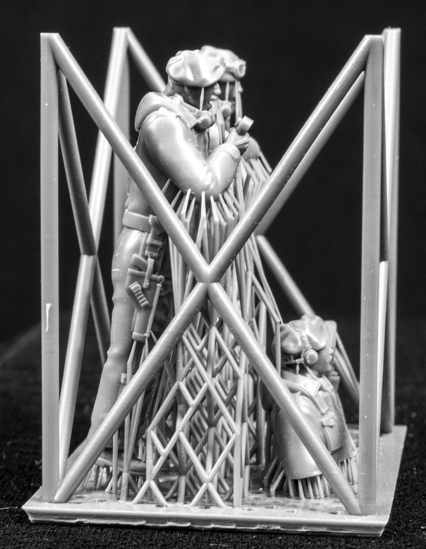 Four 3D Printed figures on a frame set on a black background.