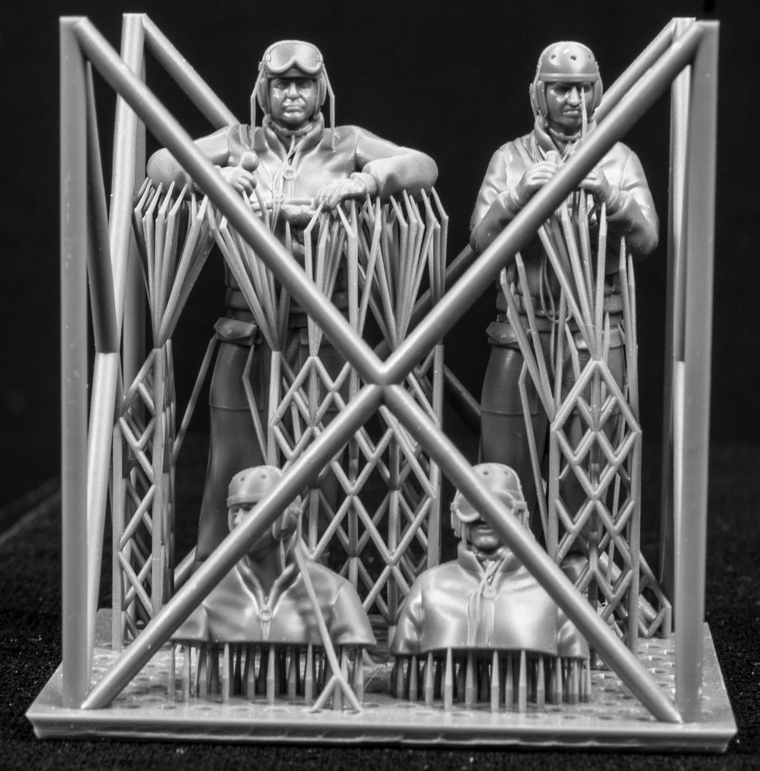 Four 3D Printed figures on a frame set on a black background.
