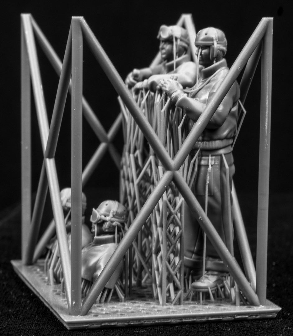 Four 3D Printed figures on a frame set on a black background.