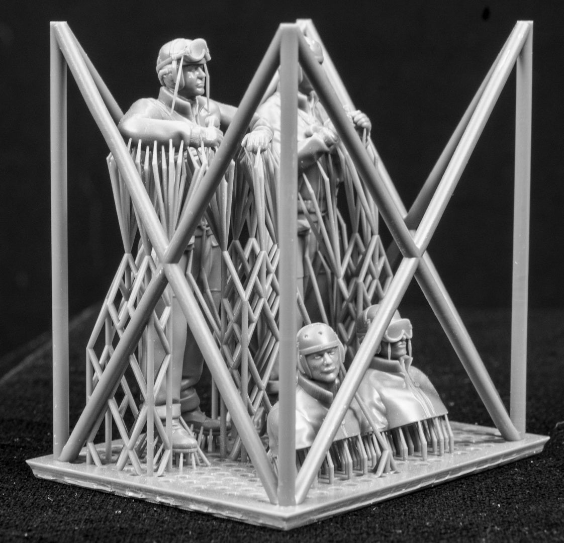 Four 3D Printed figures on a frame set on a black background.