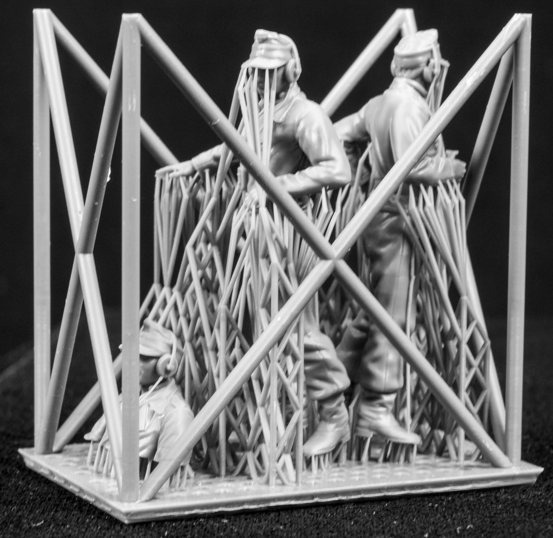Three 3D Printed figures on a frame set on a black background.