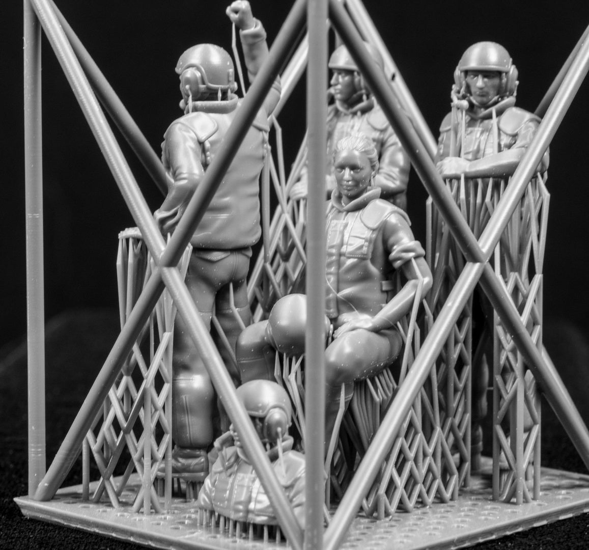 Five 3D Printed figures on a frame set on a black background.