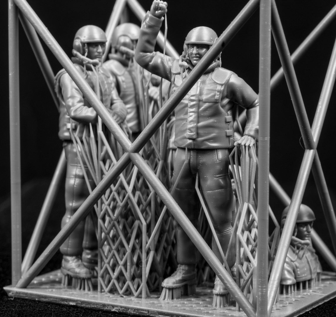 Five 3D Printed figures on a frame set on a black background.
