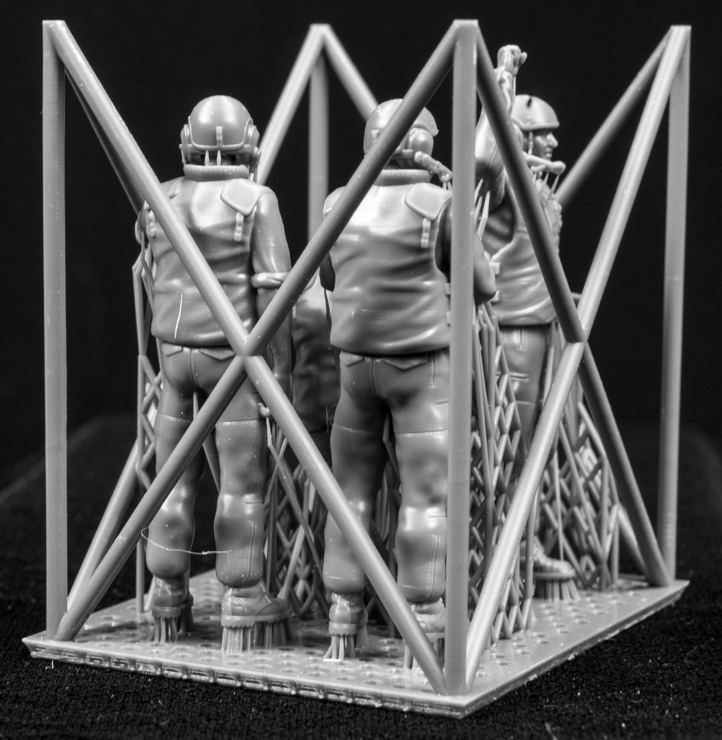 Five 3D Printed figures on a frame set on a black background.