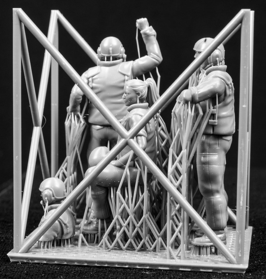 Five 3D Printed figures on a frame set on a black background.