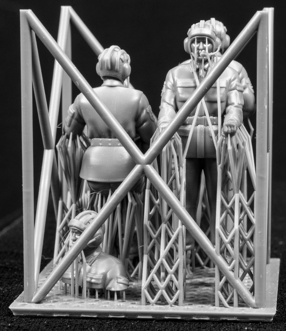 A set of 1/35 Chinese PLA AFV Crew 3D printed figures on a frame with a black background.