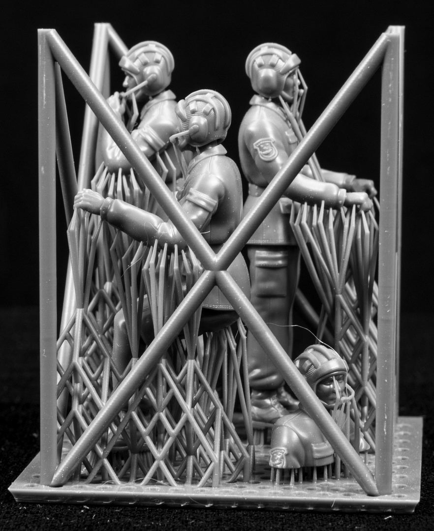 A set of 1/35 Chinese PLA AFV Crew 3D printed figures on a frame with a black background.