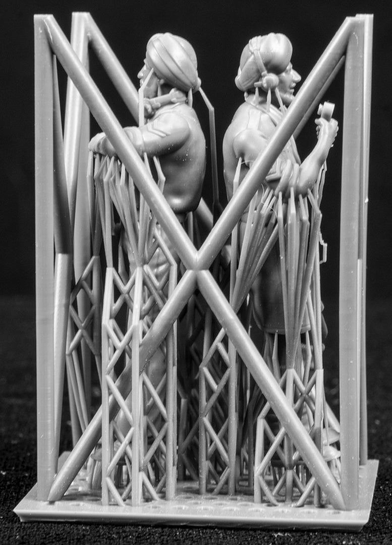 Two figures in a cage on a black background