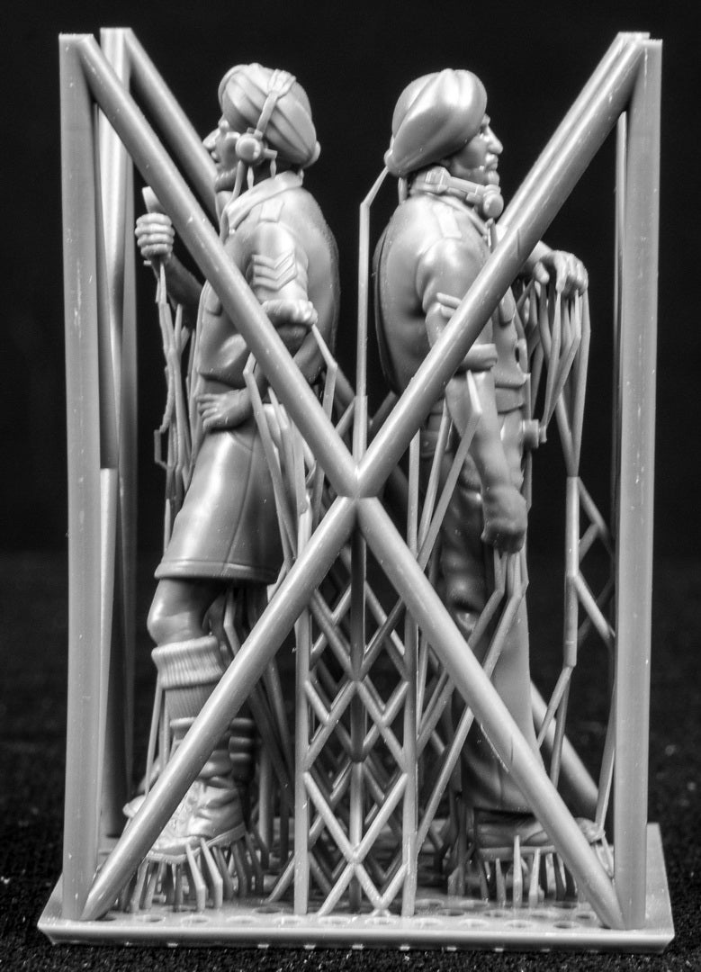 Two figures in a cage on a black background