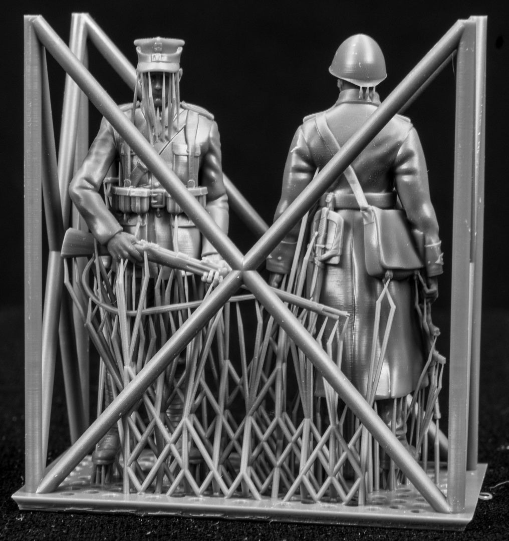 Two figures in a cage on a black background