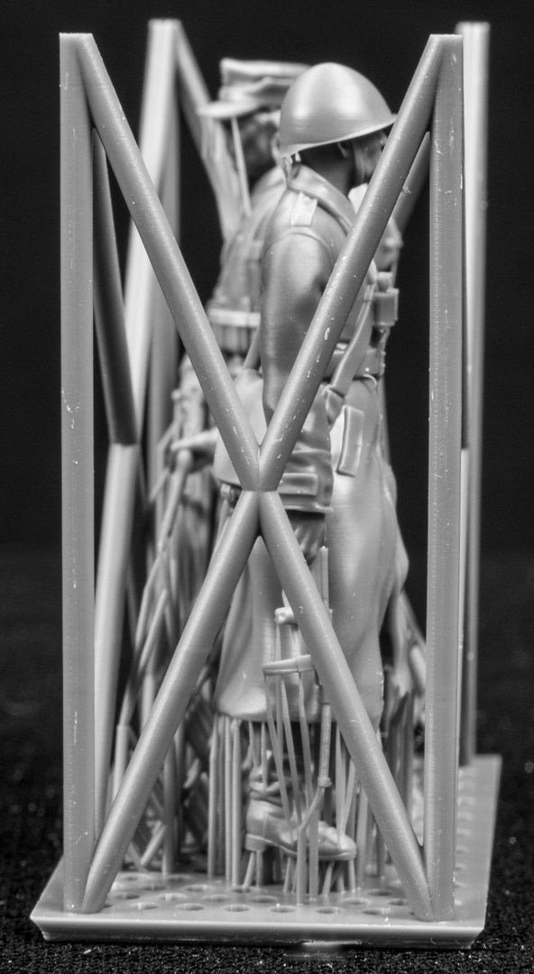 Two figures in a cage on a black background