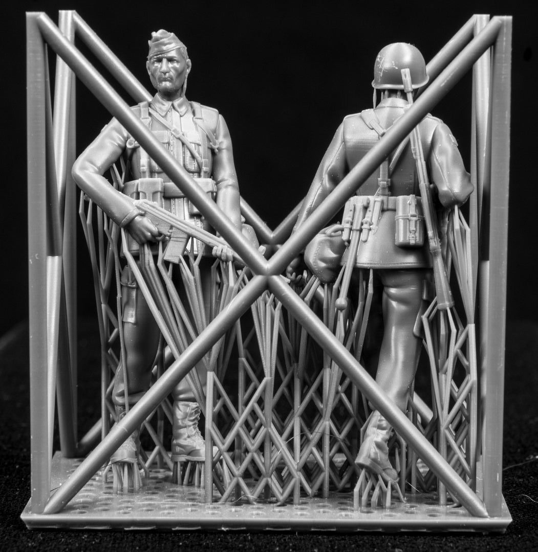 Two figures in a cage on a black background