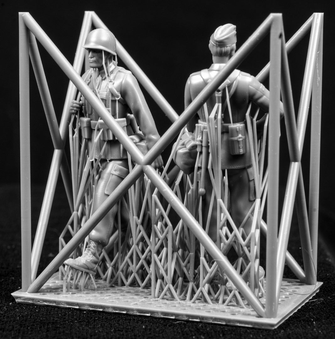 Two figures in a cage on a black background