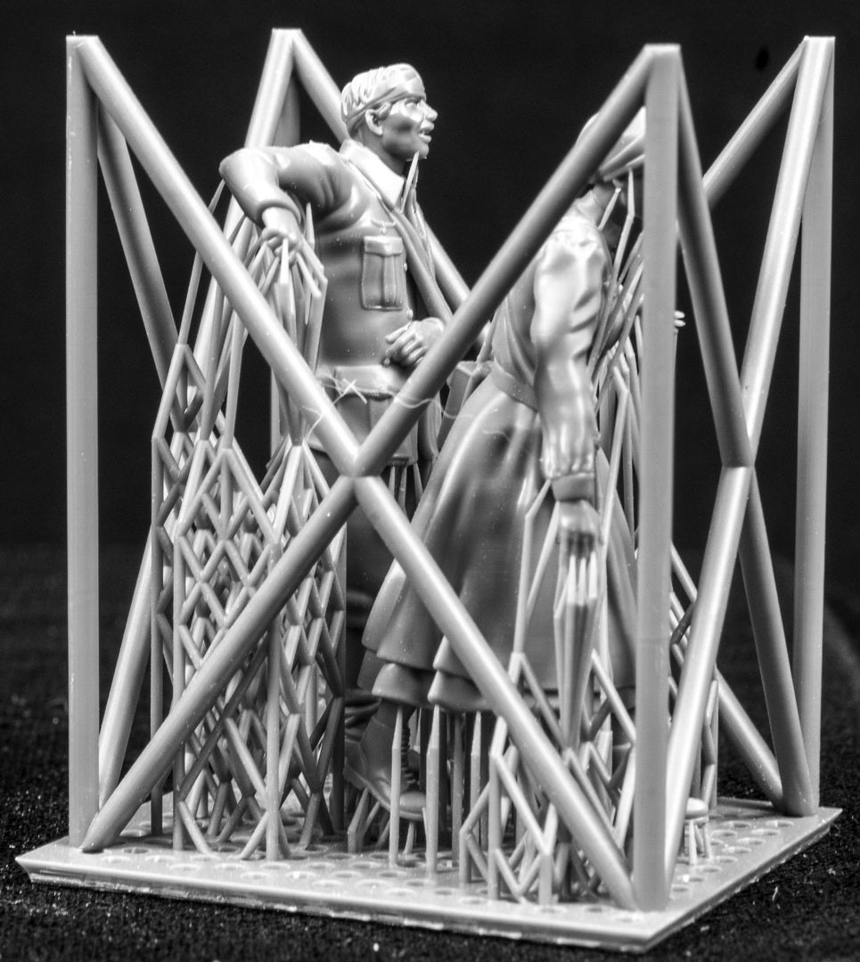 Two 3D Printed figures on a frame set on a black background.