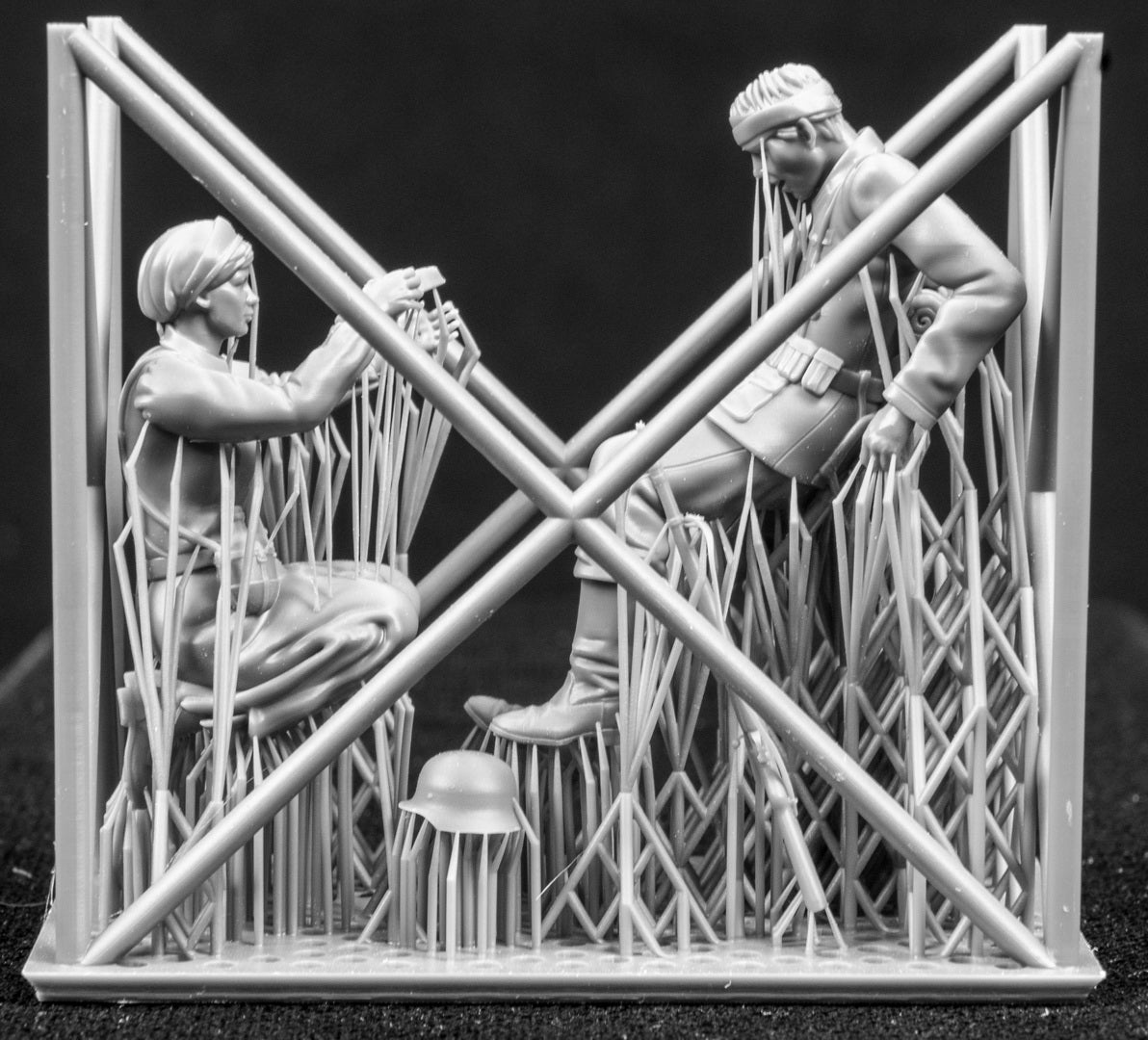 Two 3D Printed figures on a frame set on a black background.