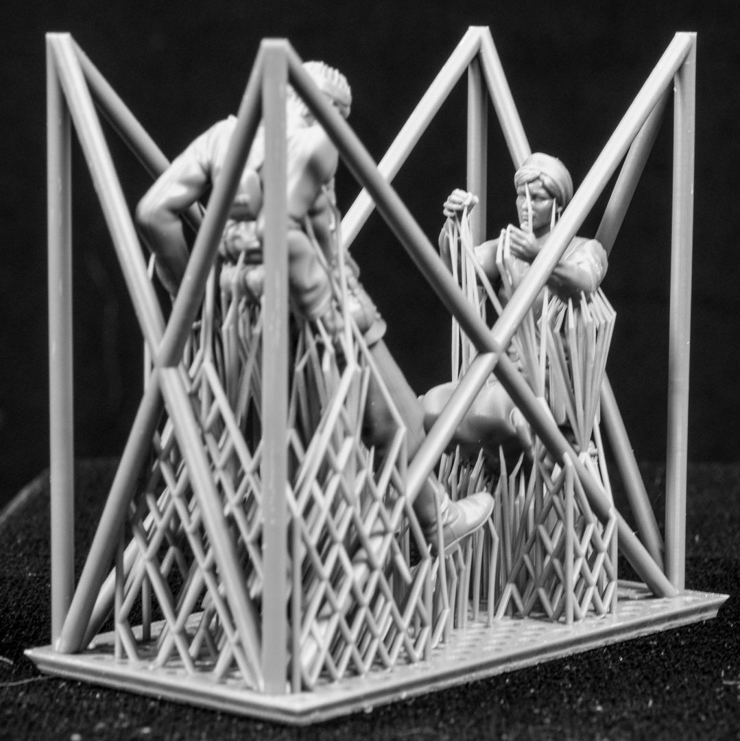Two 3D Printed figures on a frame set on a black background.