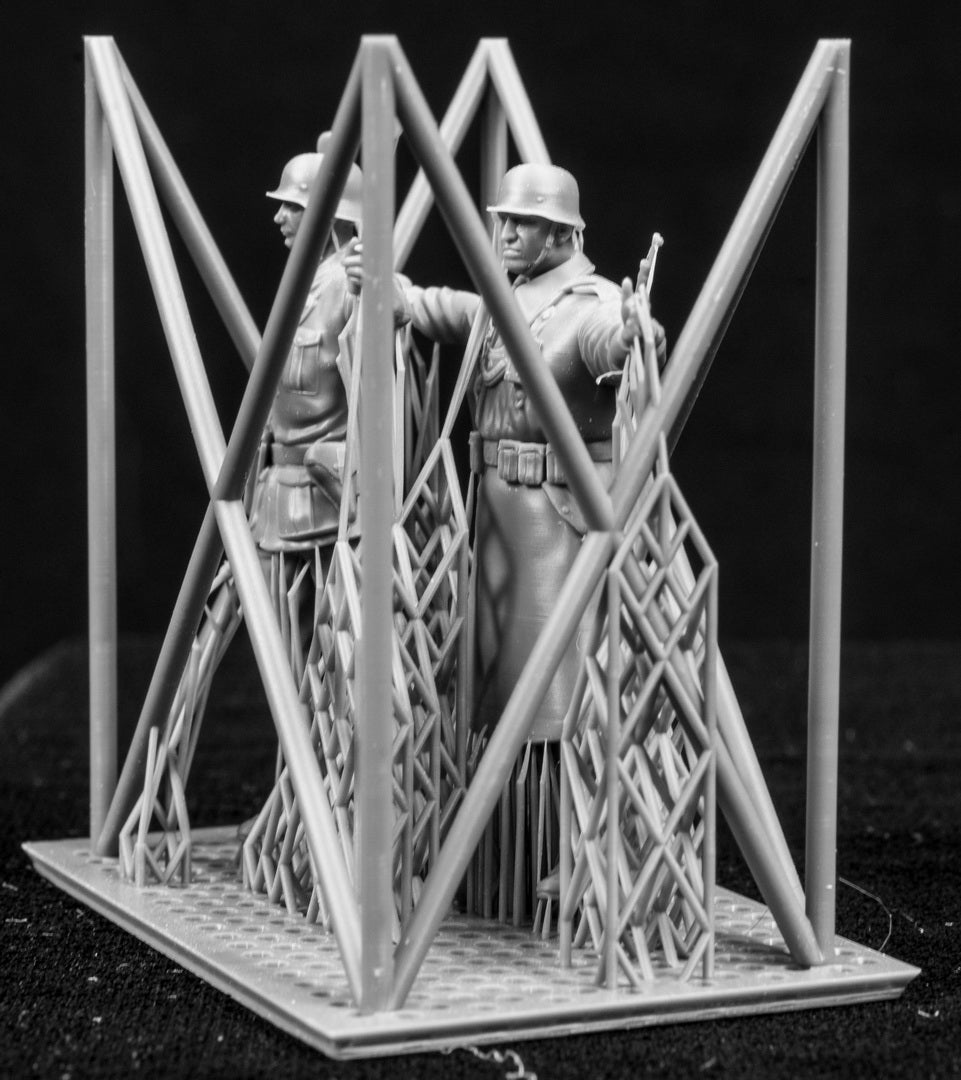 Two 3D Printed figures on a frame set on a black background.