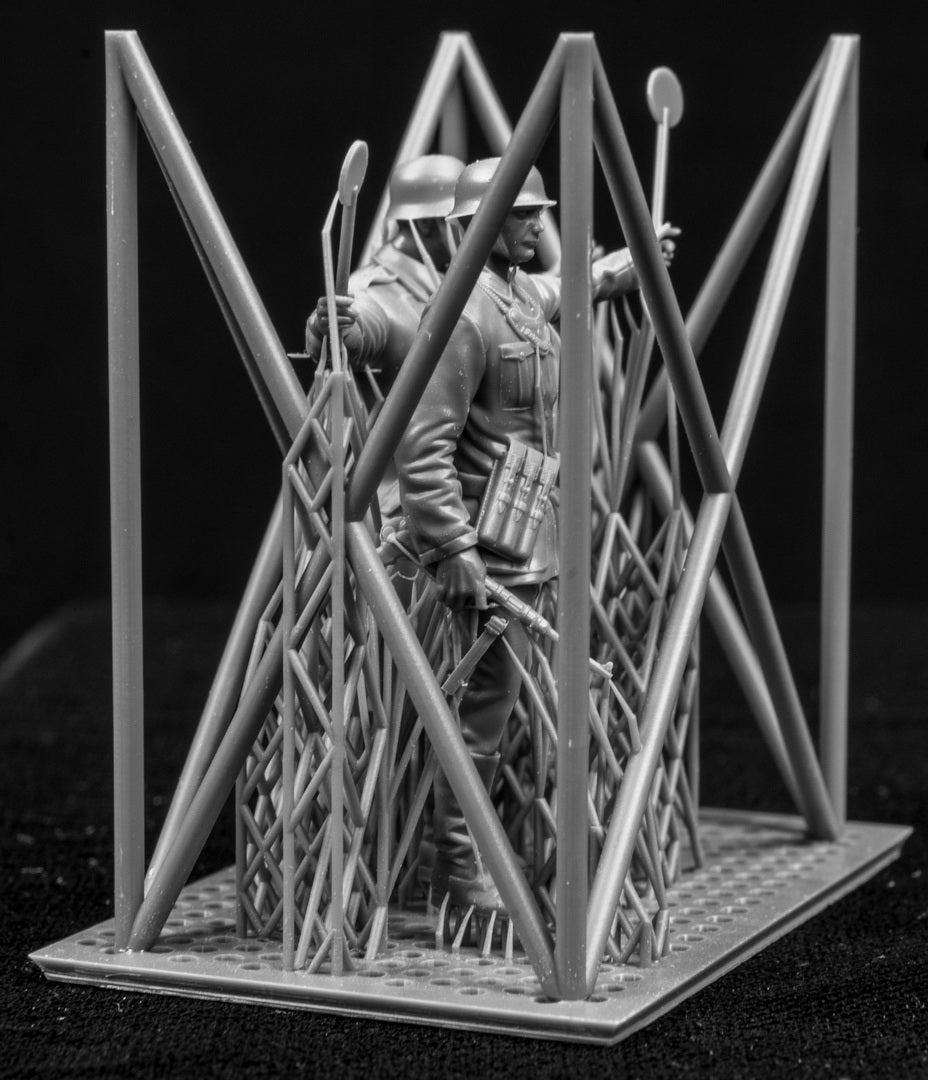 Two 3D Printed figures on a frame set on a black background.