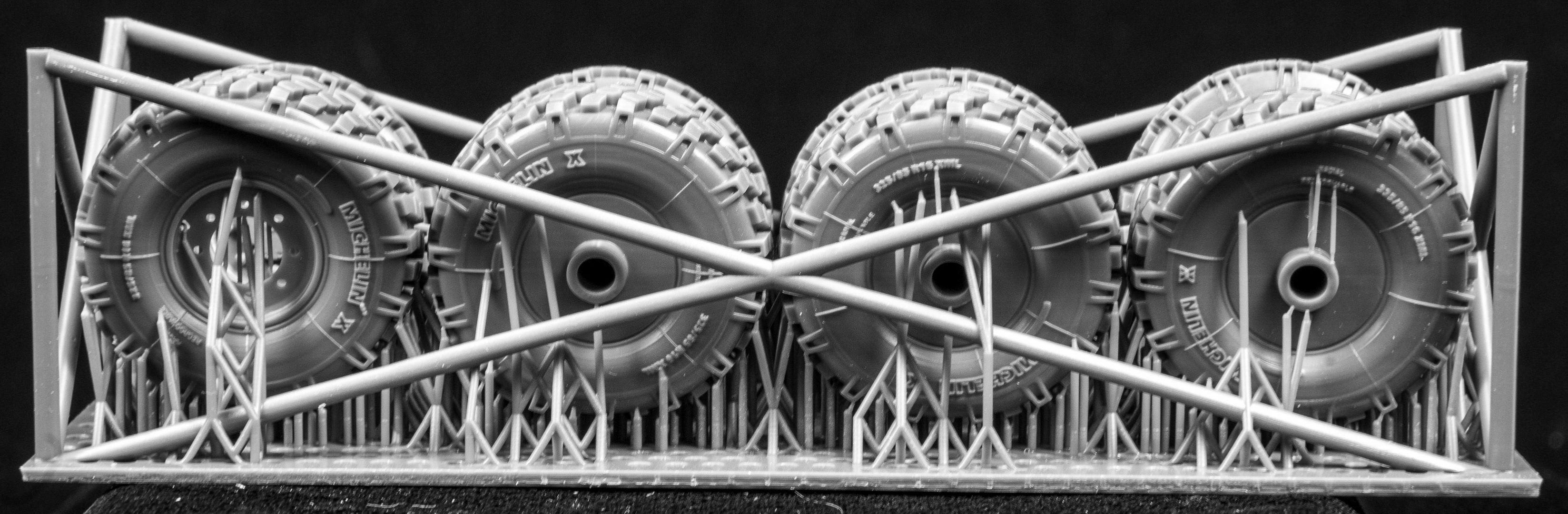  Canadian AVGP Weighted Wheel Set (Late Pattern). Six Tires, two spares on 3D printed frame on black background.
