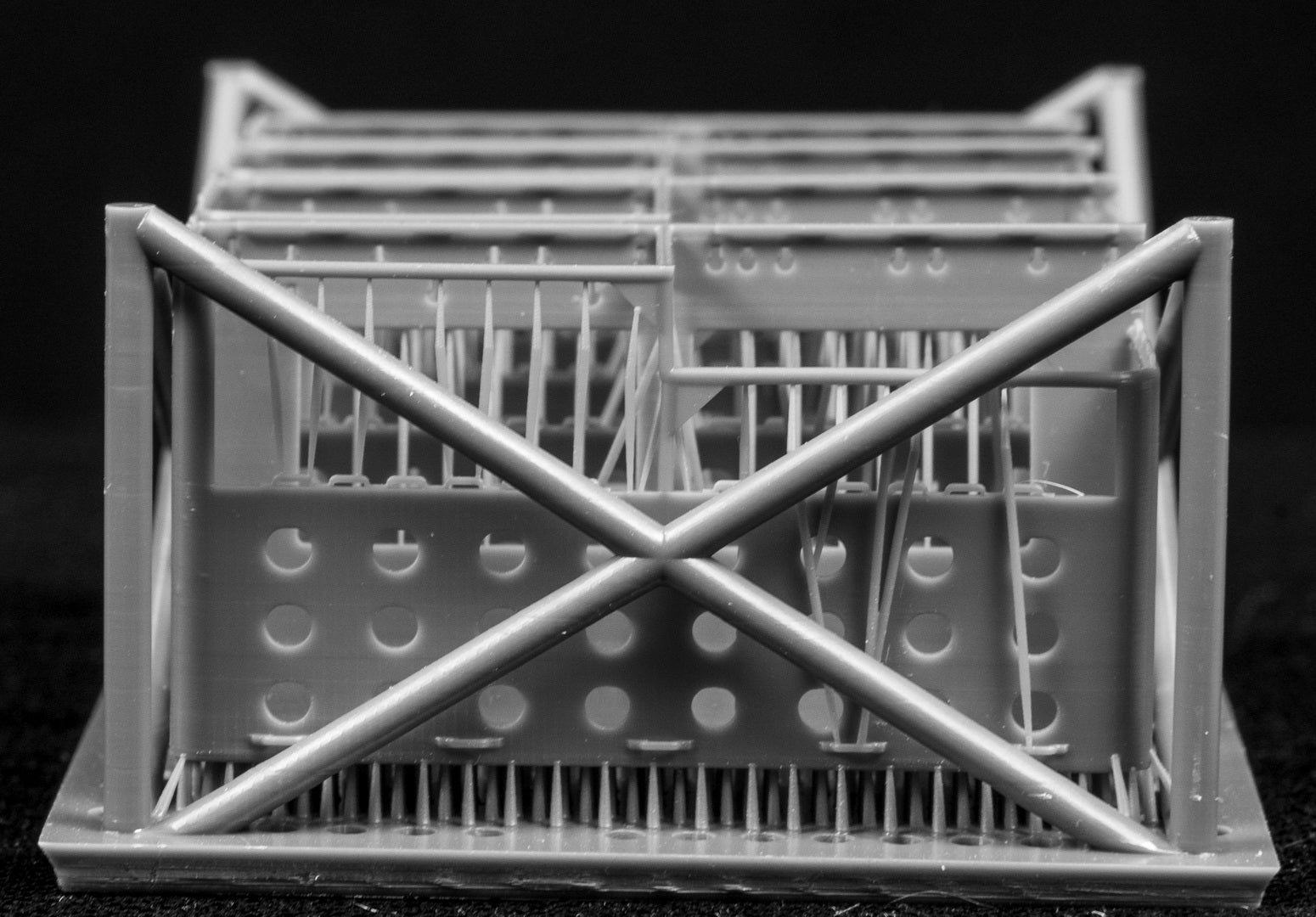 LAV III LORIT storage bins in a cage-like structure on a black background