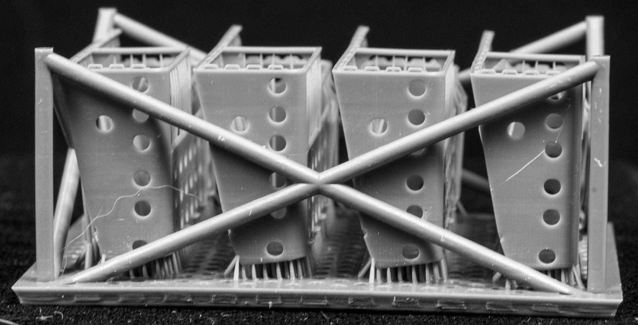 LAV III LORIT storage bins in a cage-like structure on a black background