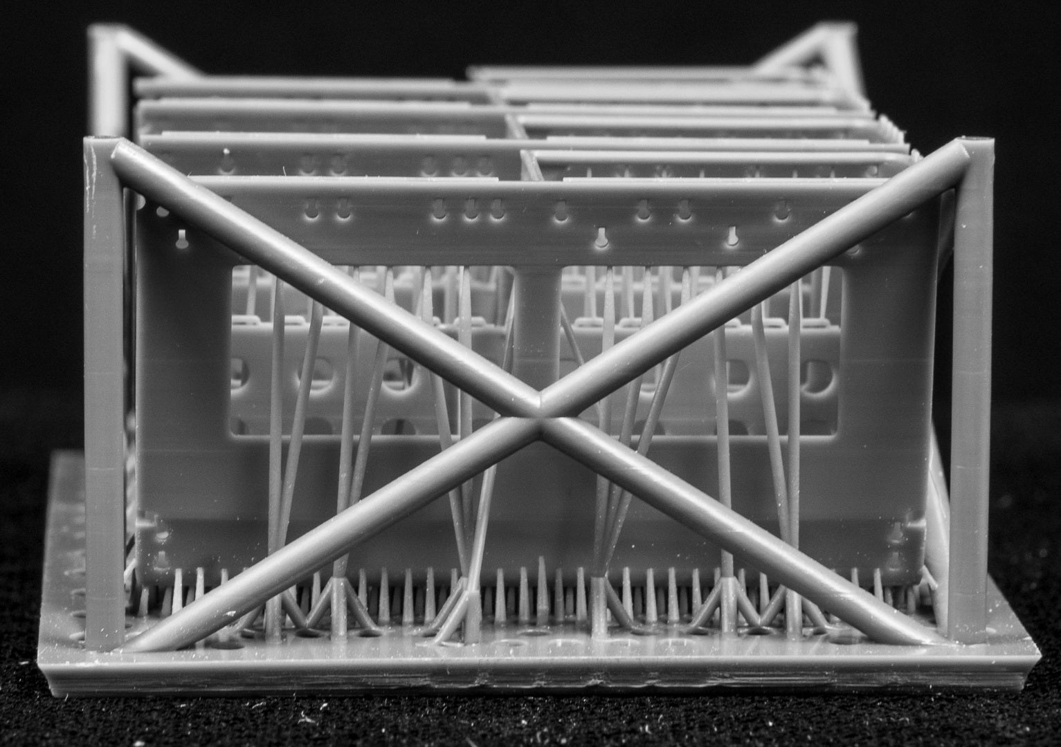 LAV III LORIT storage bins in a cage-like structure on a black background