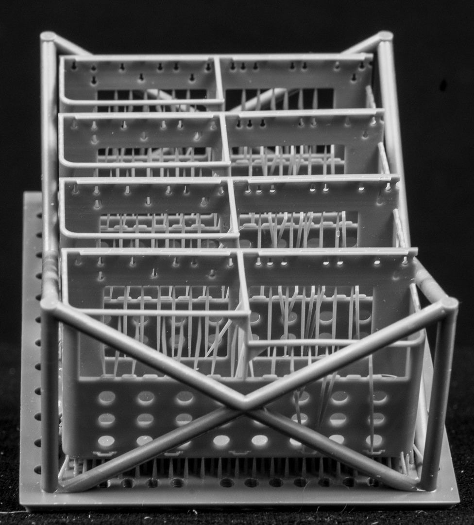 LAV III LORIT storage bins in a cage-like structure on a black background
