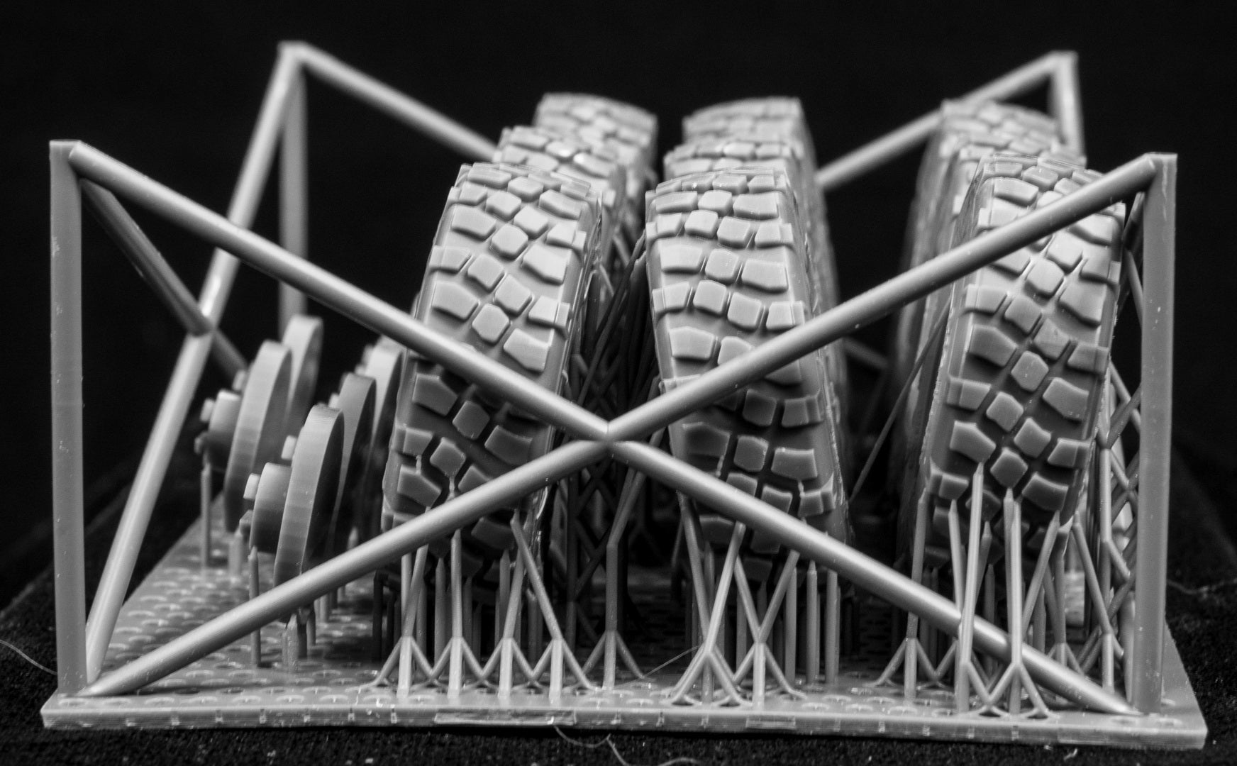 Eight LAV III Late Weighted wheelsets plus spare on a 3d printed base on a black background

