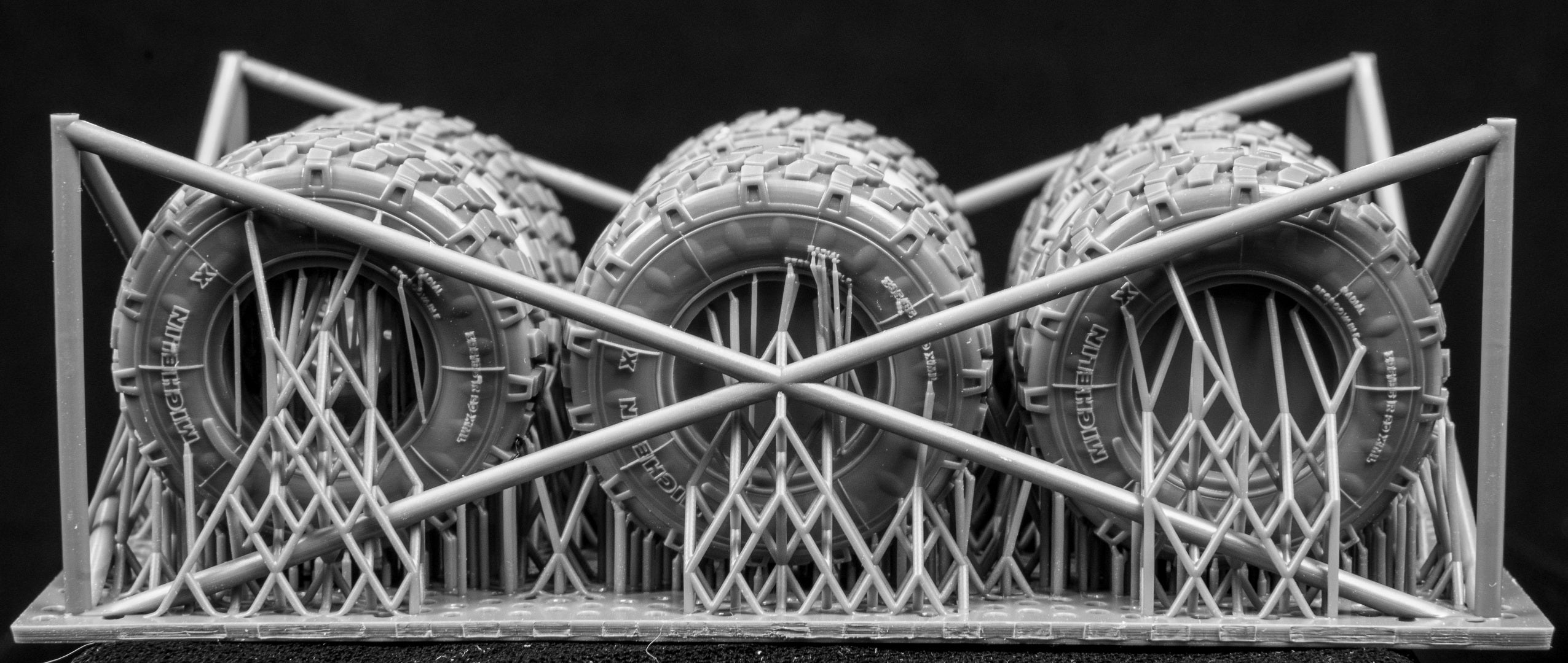 Eight LAV III Late Weighted wheelsets plus spare on a 3d printed base on a black background