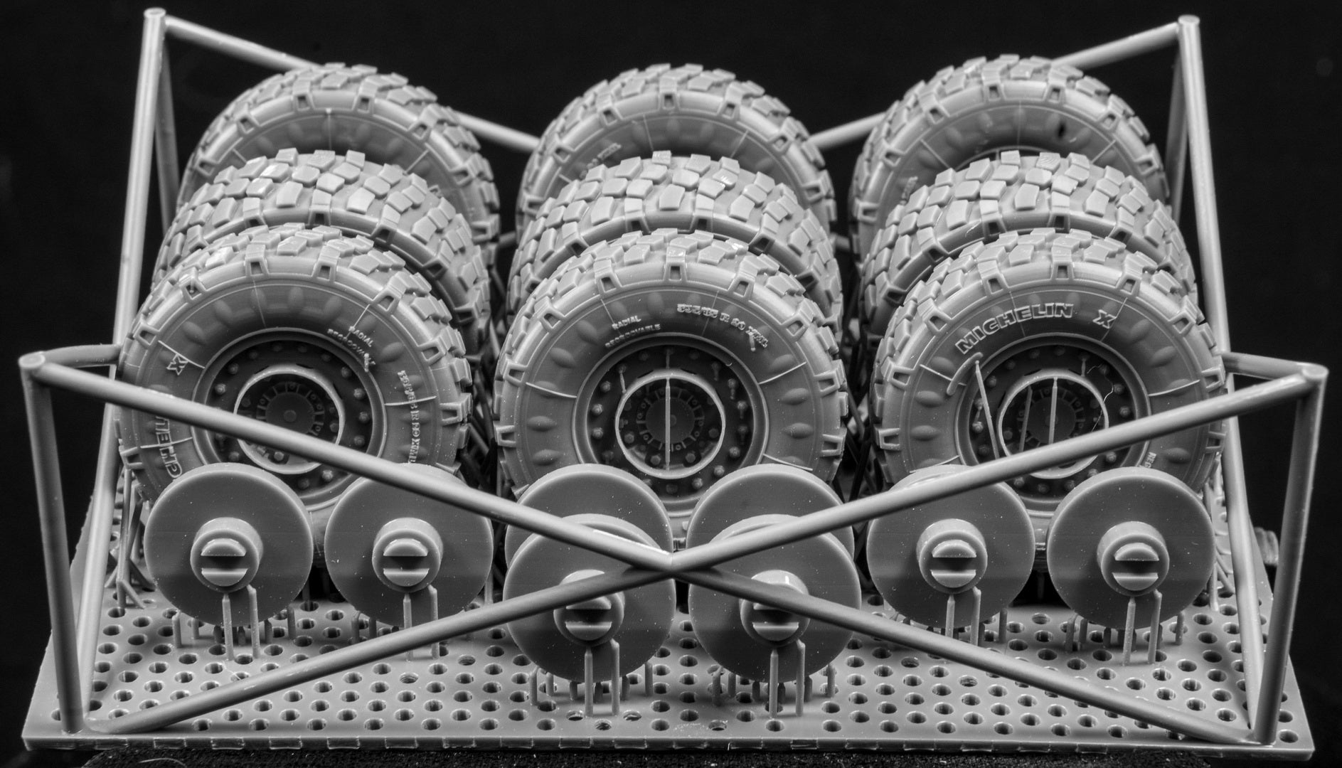 Eight LAV III Late Weighted wheelsets plus spare on a 3d printed base on a black background