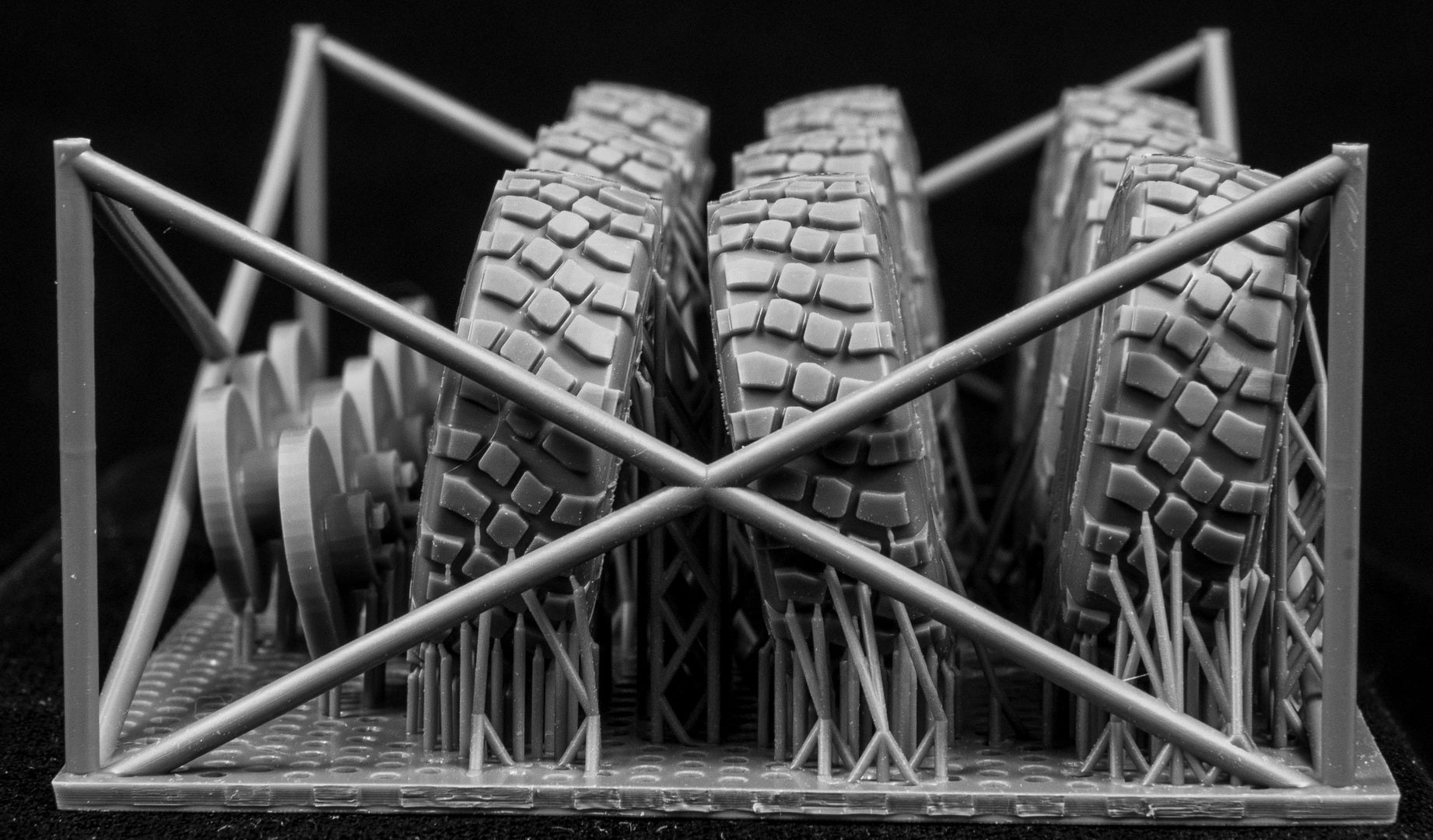 Eight LAV III Early Weighted wheelsets plus spare on a 3d printed base on a black background