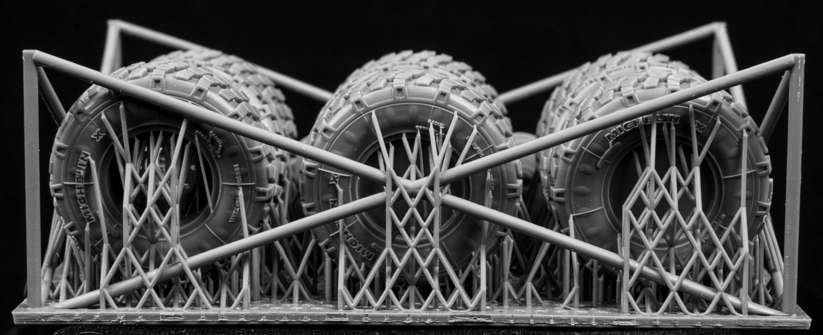 Eight LAV III Early Weighted wheelsets plus spare on a 3d printed base on a black background