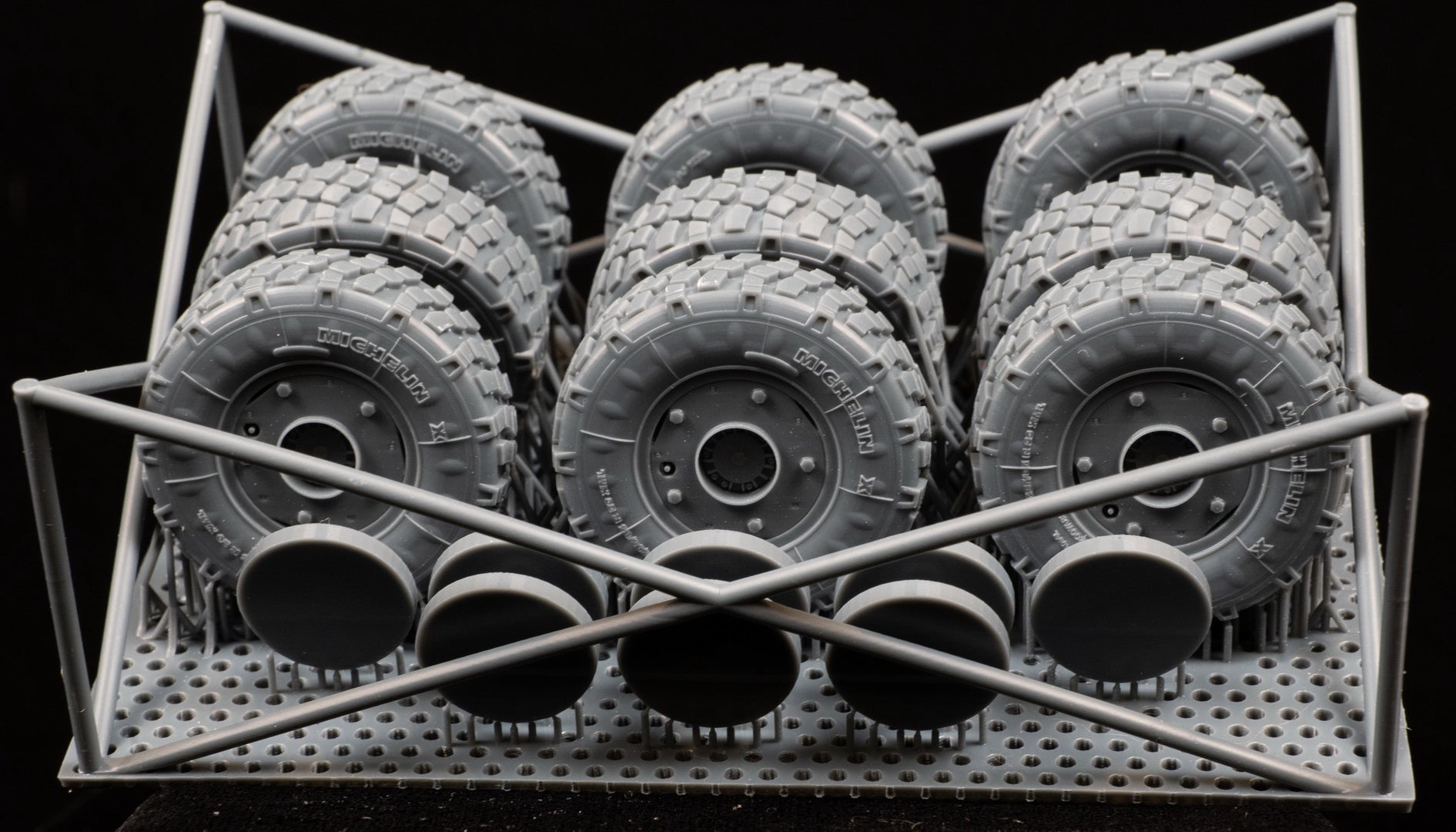 Eight LAV III Early Weighted wheelsets plus spare on a 3d printed base on a black background